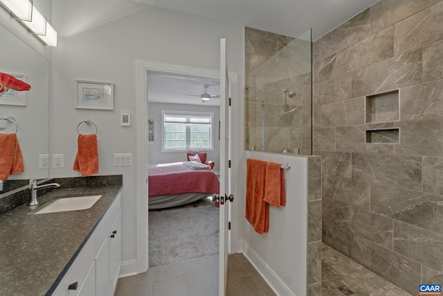 ensuite bathroom featuring tile patterned flooring, a walk in shower, vanity, and ensuite bathroom