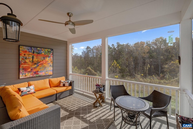 sunroom / solarium with a ceiling fan