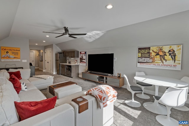 living room featuring recessed lighting, baseboards, light carpet, and lofted ceiling