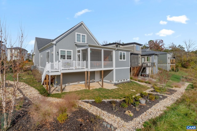 rear view of property featuring stairs, central AC, and a sunroom