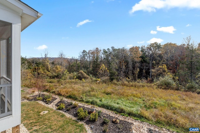 exterior space with a wooded view