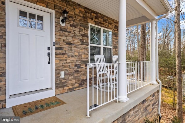 doorway to property featuring a porch