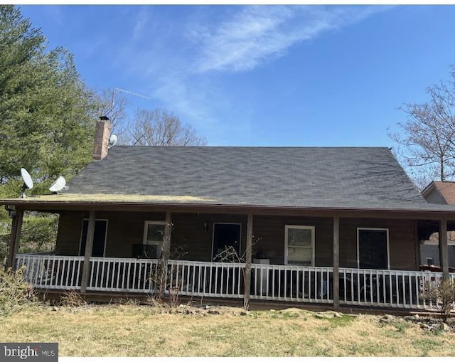 view of front of house featuring a porch and a chimney