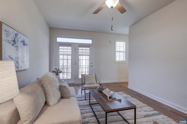 living room featuring dark hardwood / wood-style floors and ceiling fan