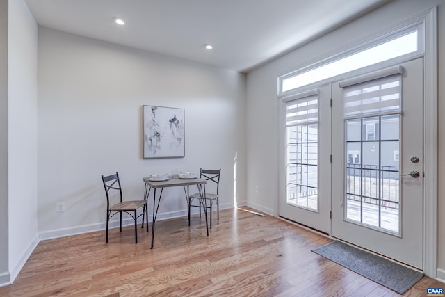 dining room featuring light wood-type flooring and a wealth of natural light