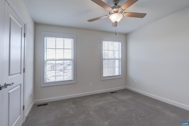 carpeted spare room with ceiling fan