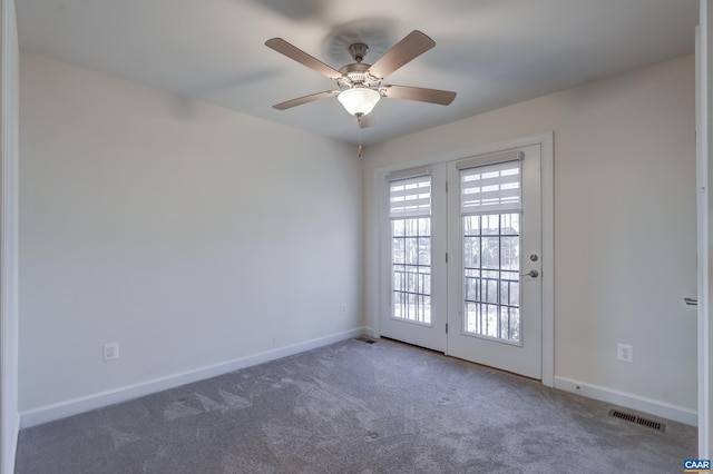 carpeted spare room with ceiling fan