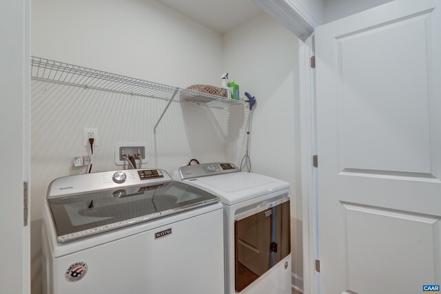 clothes washing area with washing machine and clothes dryer