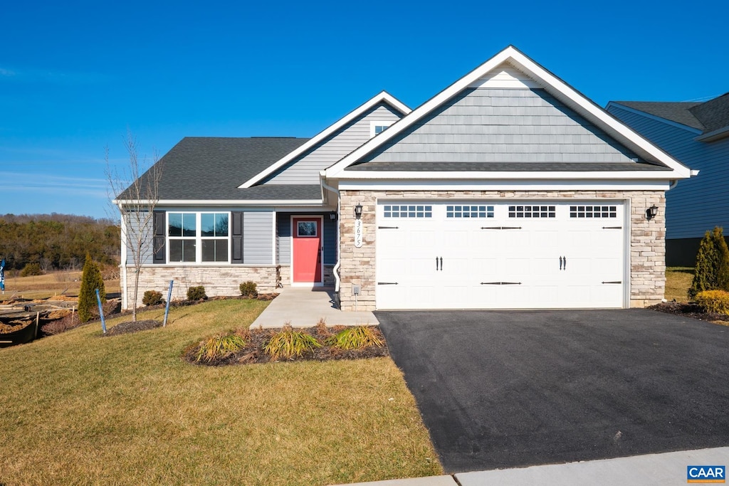 craftsman-style home featuring a garage and a front lawn