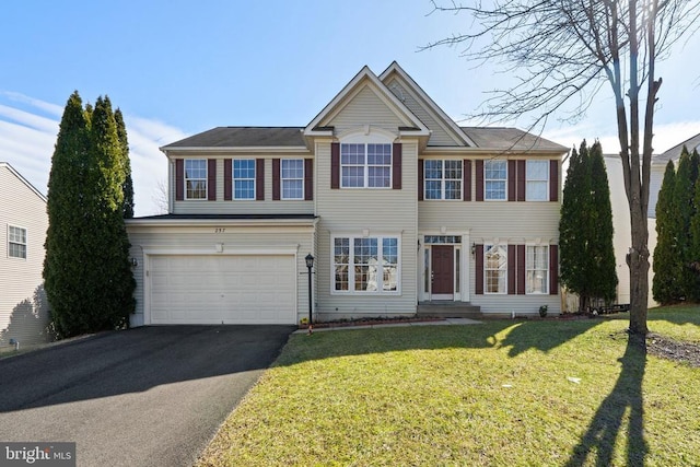 view of front facade with a front lawn and a garage