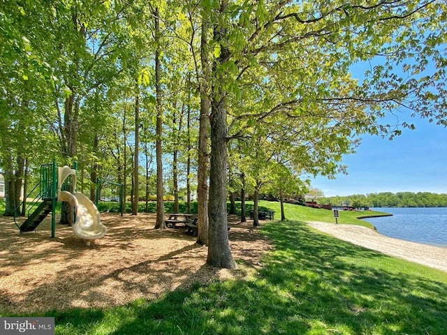 view of home's community with a lawn, a water view, and playground community