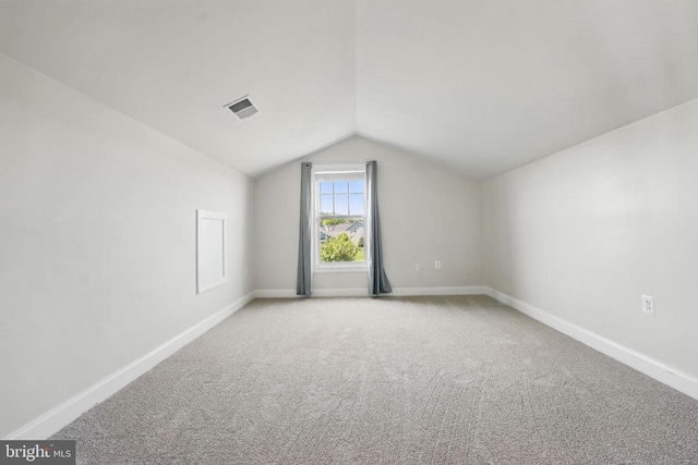 bonus room with carpet flooring, baseboards, visible vents, and lofted ceiling