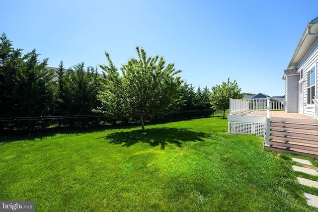 view of yard featuring fence and a wooden deck