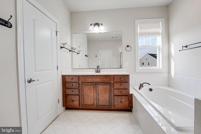 full bath featuring vanity, tile patterned flooring, a bath, and visible vents