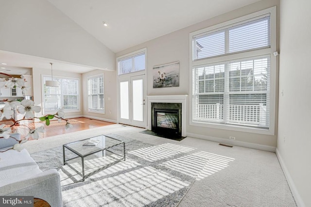 unfurnished living room featuring baseboards, visible vents, and a healthy amount of sunlight