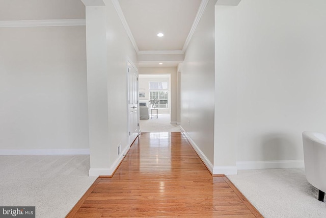 corridor featuring crown molding, recessed lighting, baseboards, and light wood-style floors