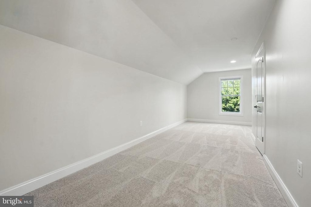 bonus room with baseboards, vaulted ceiling, and carpet