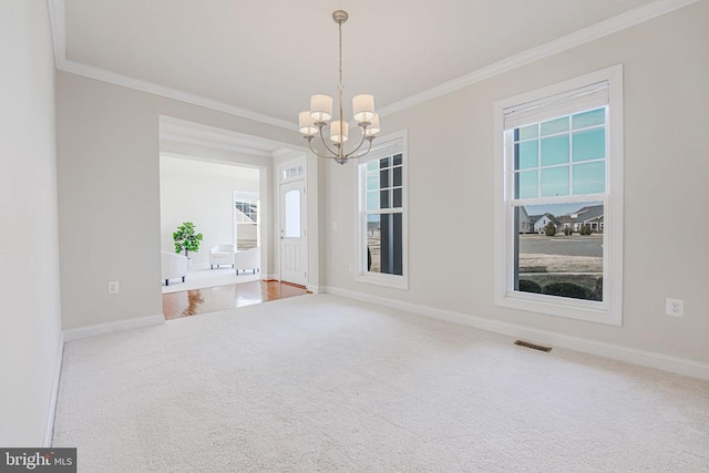carpeted empty room featuring visible vents, ornamental molding, baseboards, and a notable chandelier