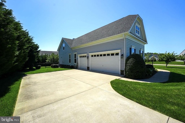view of side of property with a lawn, a shingled roof, driveway, and a garage