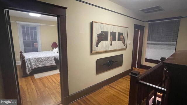 bedroom with dark hardwood / wood-style floors