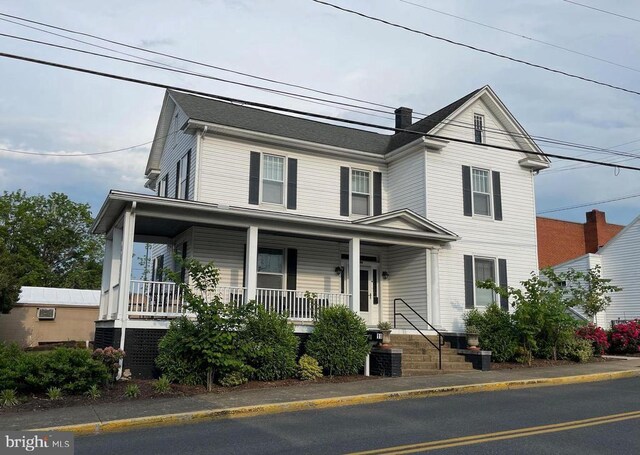 view of front of property featuring cooling unit and a porch