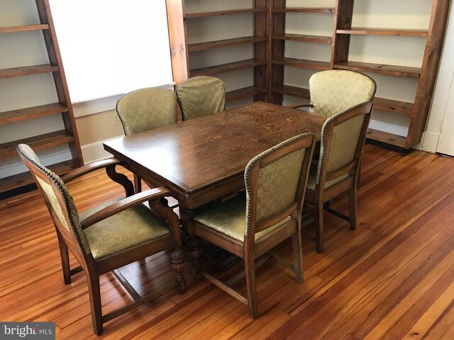 dining space with hardwood / wood-style floors