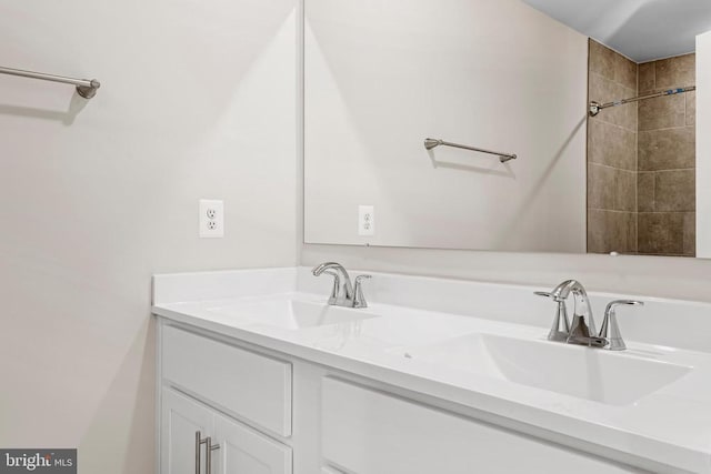 full bathroom featuring double vanity and a sink