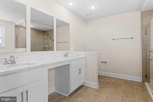 bathroom featuring a sink, visible vents, double vanity, and a shower stall