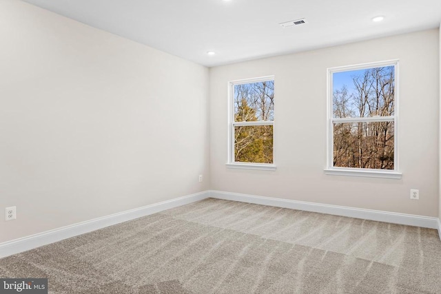 empty room featuring recessed lighting, carpet, and baseboards