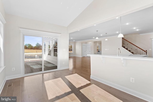 interior space with visible vents, a sink, baseboards, and wood finished floors