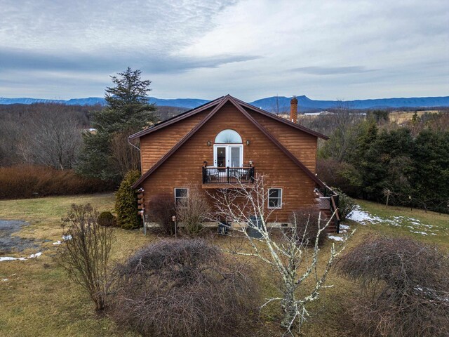 back of house with a deck with mountain view