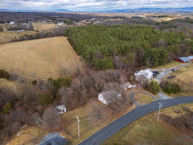 birds eye view of property featuring a mountain view and a forest view