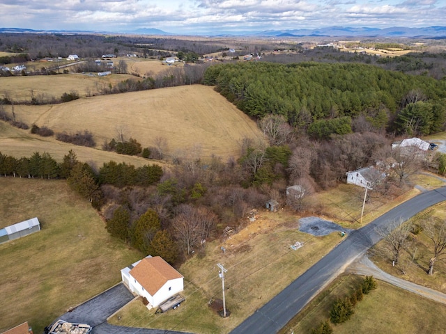 aerial view featuring a rural view and a wooded view