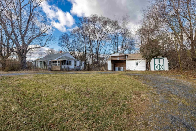 view of yard with a storage shed, covered porch, and an outdoor structure