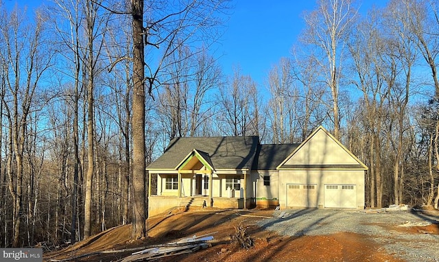 view of front facade featuring a garage, driveway, and a porch