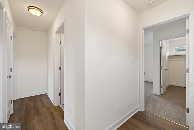 hallway with dark hardwood / wood-style floors