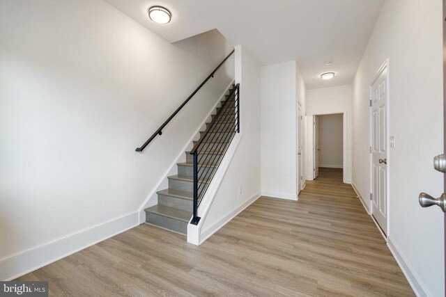 staircase with hardwood / wood-style flooring