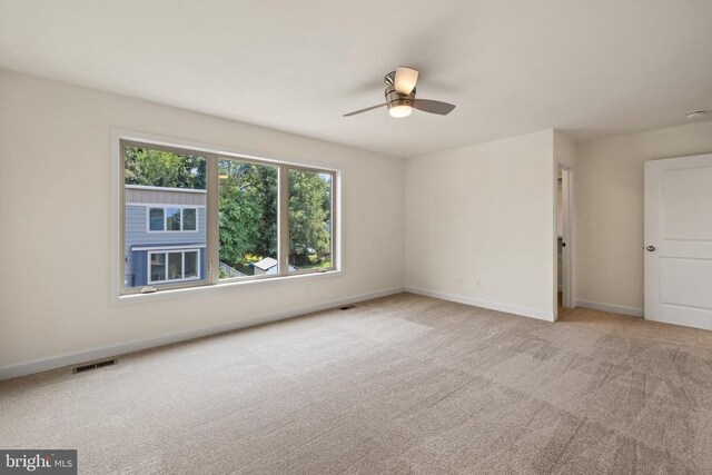 unfurnished room featuring light colored carpet and ceiling fan