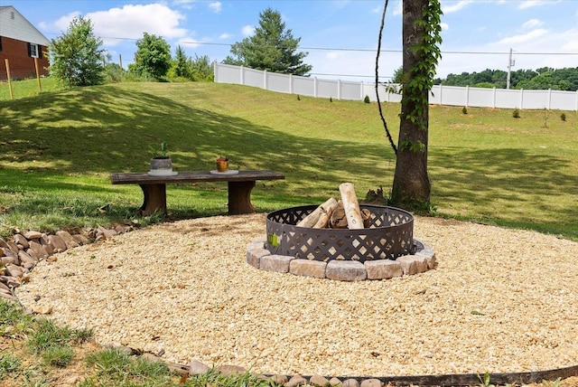 view of yard with an outdoor fire pit and fence