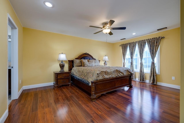 bedroom with visible vents, baseboards, and dark wood-type flooring