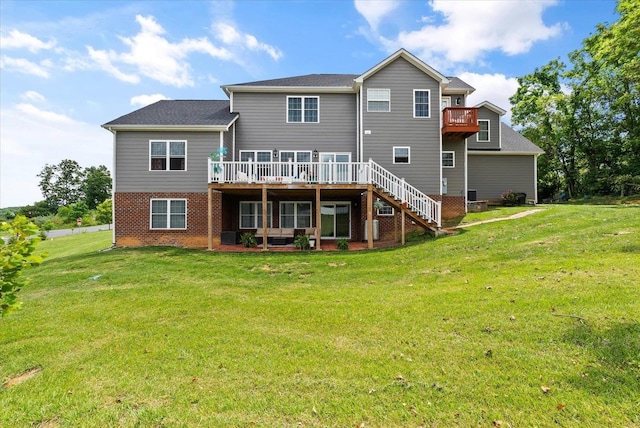 rear view of house with brick siding, stairs, a deck, and a yard