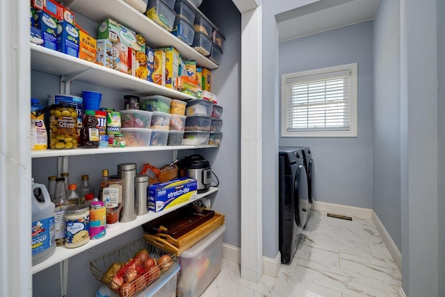 storage area with washer and clothes dryer