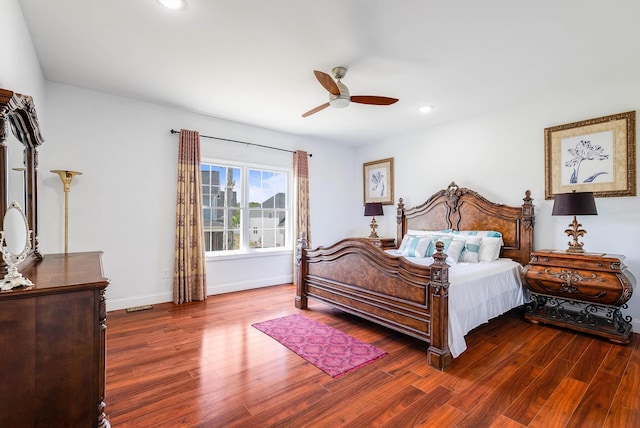 bedroom featuring visible vents, baseboards, ceiling fan, and dark wood-type flooring