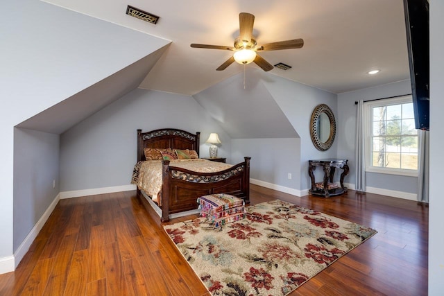 bedroom with lofted ceiling, dark wood-style flooring, visible vents, and baseboards