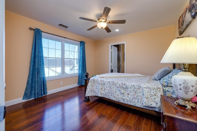 bedroom featuring dark wood-style flooring, visible vents, ceiling fan, and baseboards