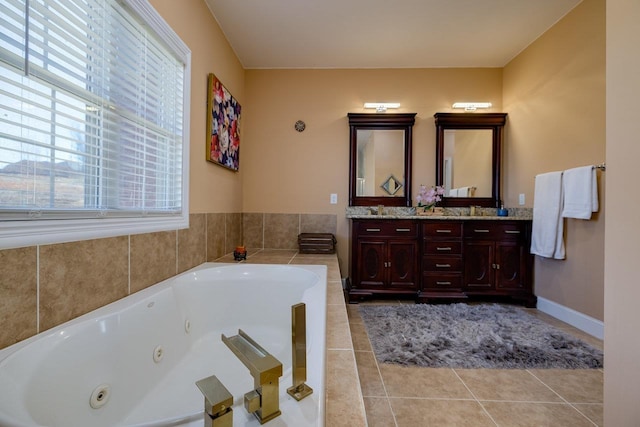 full bathroom with double vanity, plenty of natural light, a tub with jets, and tile patterned flooring