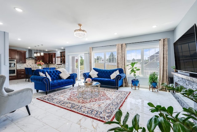 living room featuring marble finish floor and recessed lighting