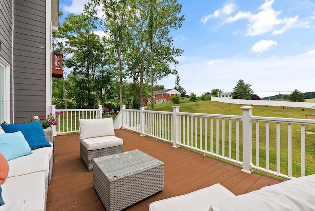 wooden deck featuring an outdoor living space and a yard