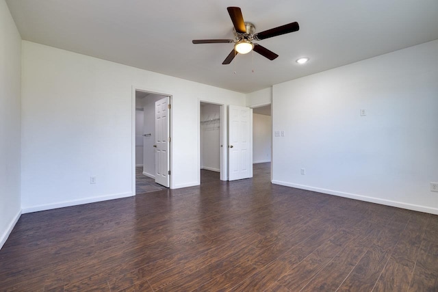 interior space with dark wood-style floors, baseboards, and a ceiling fan