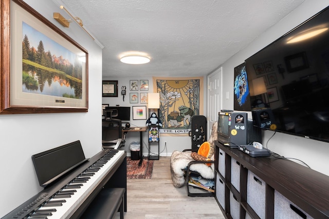 home office featuring a textured ceiling and wood finished floors